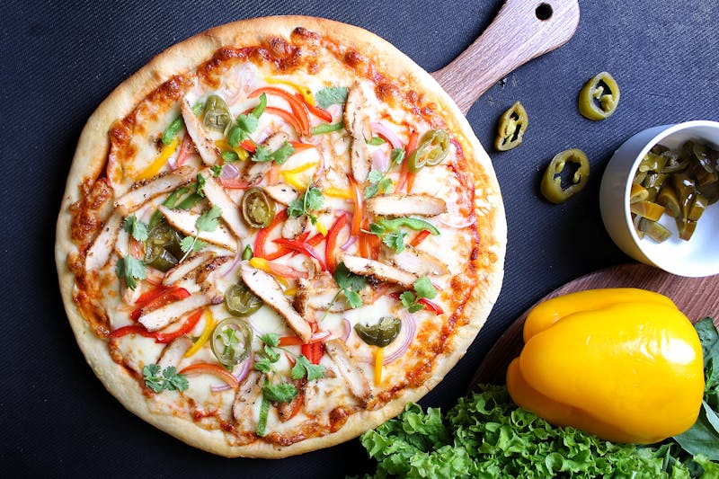Prosciutto e Rucola punch pizza with arugula and prosciutto