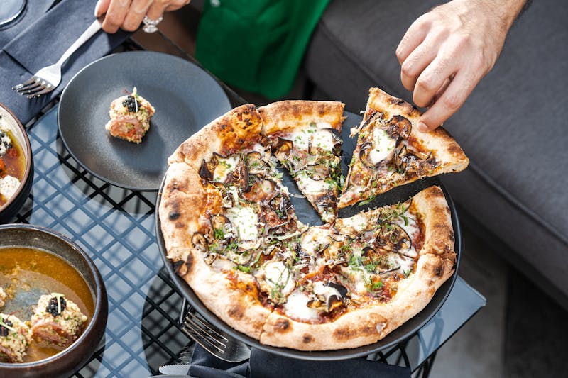 Truffle and mushroom punch pizza with arugula